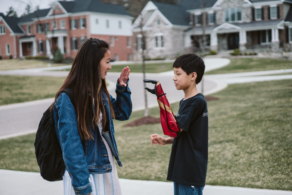 Boy with bionic Hero Arm plays with his sister